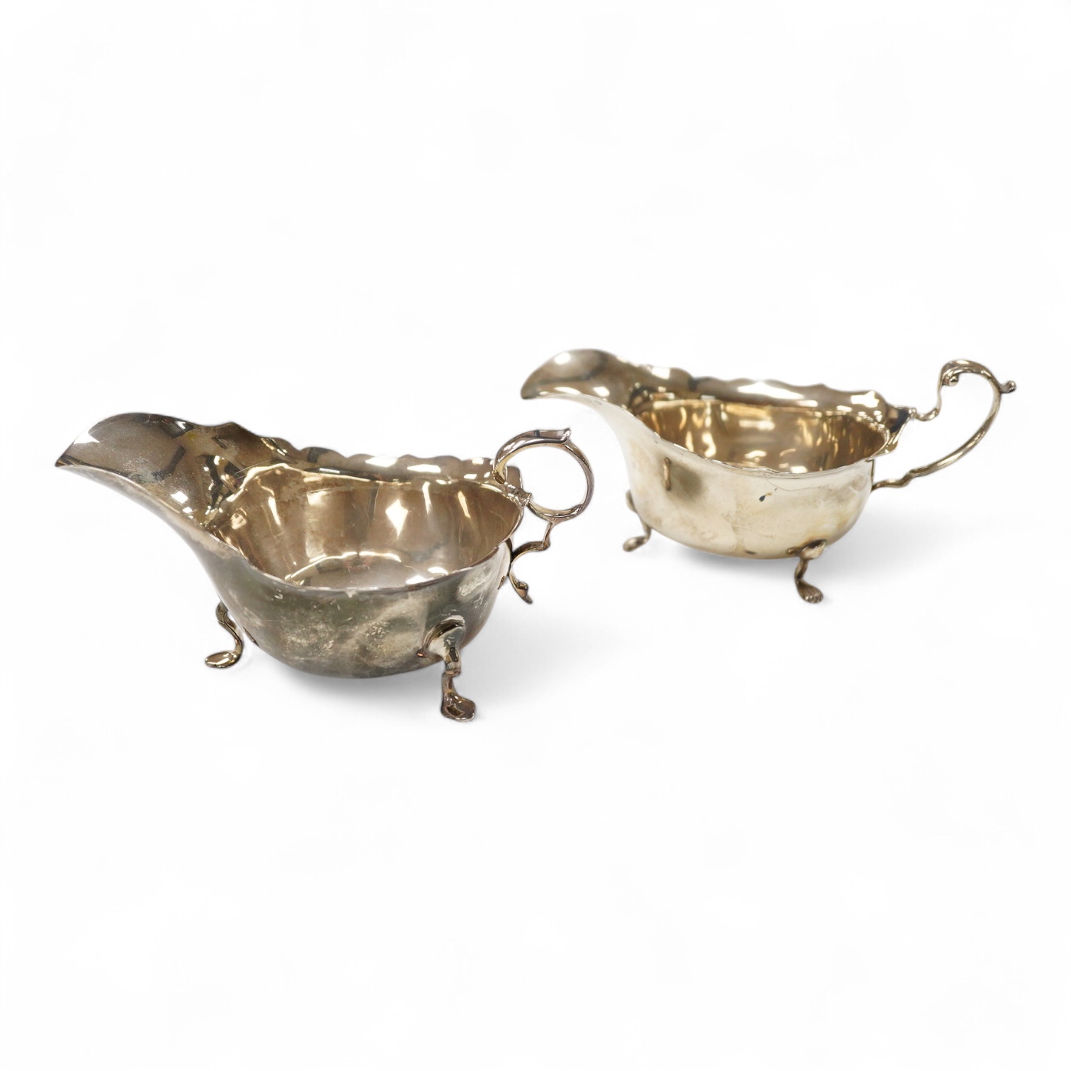 Two George V silver sauceboats, William Hutton & Sons, Birmingham, 1910 and S. Blanckensee & Sons, Birmingham, 1916, both approx. 16cm in length, 7.1oz.
